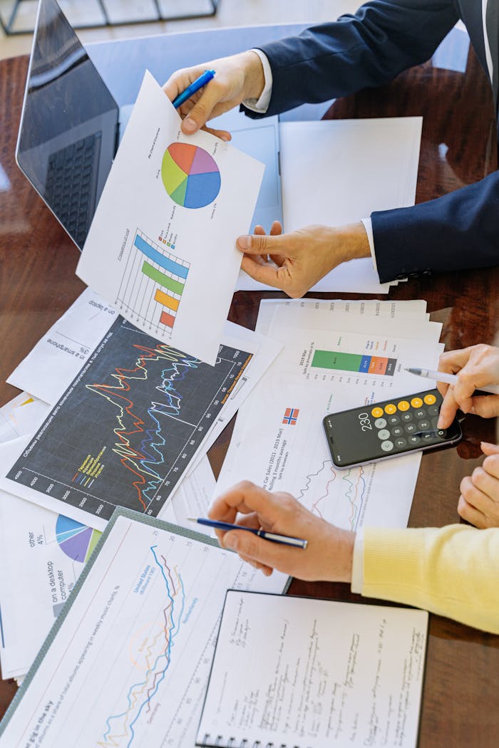 services-02 Business professionals analyzing financial charts and graphs during a meeting.