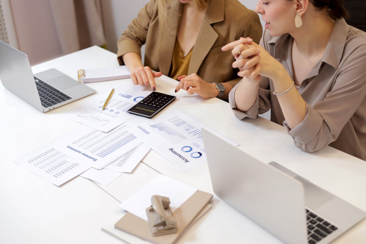 our-story Two professionals collaborating on financial documents in a modern office setting.